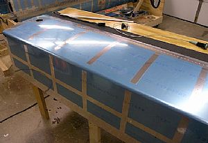 Started removing the blue plastic film from the right tank skin