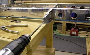 Enlarged the pre-punched 1/8 holes using a #30 drill bit  