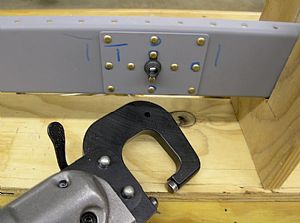 Rivet on the 2 E-910 reinforcement plates and K1000-6 nut plates to the spar