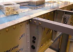 Riveted in the forward floor angles aft