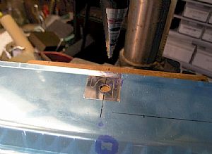 Next. Drill the holes where the seat belts cables come through