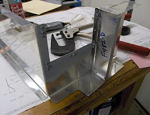 Riveted nutplates and baffle to Center Cabin Cover
